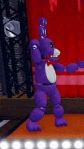 a purple teddy bear is standing on a stage with a red curtain behind him