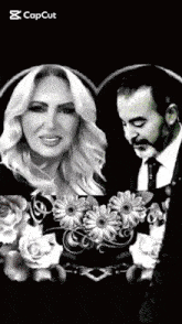 a black and white photo of a man and a woman with flowers