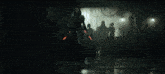 a group of people are standing in a dark room with a sign that says ' emergency exit ' on it