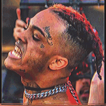 a man with a tattoo on his forehead that says " alone "