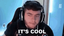 a man wearing headphones is sitting in a chair .