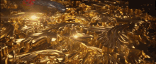 a bunch of gold pieces are laying on a black surface