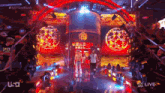 a couple of men are walking on a stage with a sign that says ' nxt gold rush ' on it