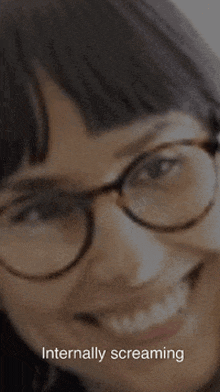 a close up of a woman wearing glasses and the words internally screaming
