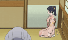 a girl in a pink kimono sits on the floor in a room