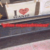a sign that says i love juanjo is hanging on a window