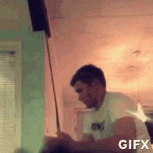 a man in a white shirt is playing a game of golf