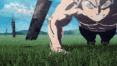 a man without a shirt is doing push ups in a field