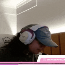 a woman wearing headphones and a hat with the name vanessasamsoa on the bottom right