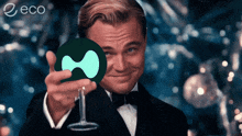 a man in a tuxedo is holding a wine glass and a coin with the word eco on the bottom