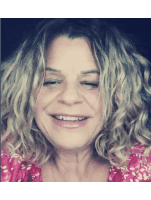 a close up of a woman 's face with her eyes closed and smiling