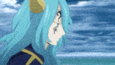 a woman with blue hair has a tattoo on her face