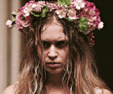 a woman wearing a flower crown on her head