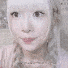 a close up of a woman 's face with white hair and braids looking at the camera .