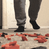 a person is jumping in the air while playing with lego blocks