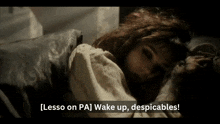 a woman laying on a bed with the words lesso on pa wake up despicables