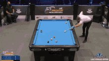 a man is playing pool in front of a table that says diamond on it