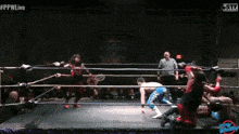 a wrestling ring with a referee and #ppwlive at the top