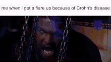 a man with chains around his neck is screaming because of crohn 's disease