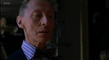 a man in a suit and tie says " deliciously " on the screen