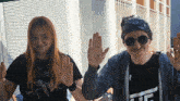 a man wearing sunglasses and a bandana is giving a high five