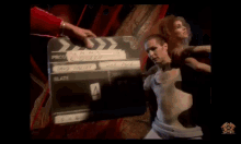 a man and a woman are dancing on a stage in a dark room .