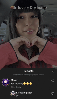 a woman is making a heart shape with her hands and the words in love = dry hump above her