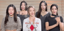a group of young women are standing next to each other clapping their hands .