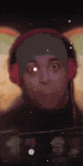 a man wearing headphones and a beanie is making a surprised face