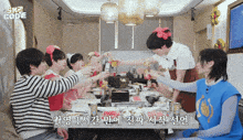 a group of people are sitting around a table with a sign above them that says sk2 code