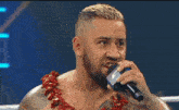 a man with a beard is holding a microphone in his hand