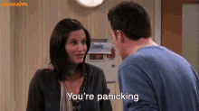 a man and a woman are standing next to each other and the woman is saying you 're panicking .