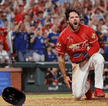 a baseball player wearing a red jersey with the word the lou on it