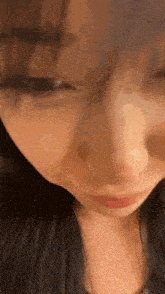 a close up of a woman 's face with her mouth open