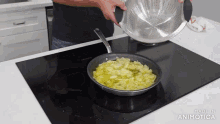a strainer is being poured into a frying pan on a stove with the words made in animatica visible