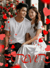 a man and a woman are sitting next to each other and the word forever is surrounded by red hearts