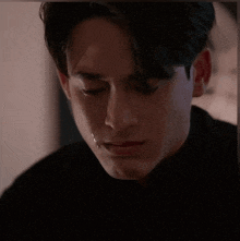 a close up of a man with a tear running down his face