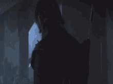 a man in a dark room with a sword