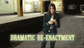 a woman standing in a subway station with the words dramatic re-enactment