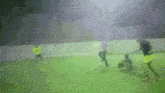 a blurry picture of people playing soccer on a green field
