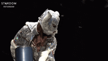 a person wearing a mask and holding a sword with the word stardom written on the bottom