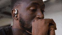a man with a beard wearing a pair of earbuds