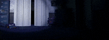 a dark room with a dresser , lamp , and a purple robot .