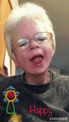 a young boy wearing glasses and a shirt that says happy on it