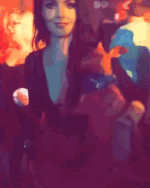 a woman in a black top is standing in a crowd