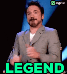 robert downey jr. is giving a thumbs up with the word legend behind him