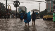 a flooded street with a mcdonald 's in the background