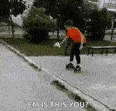 a young boy is rollerblading on a sidewalk in a park and a person is asking him if he is this you .