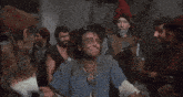 a group of men are standing together and one of them is saying " what "