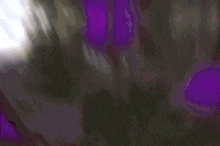 a blurry picture of a purple and green explosion with the word eaaz